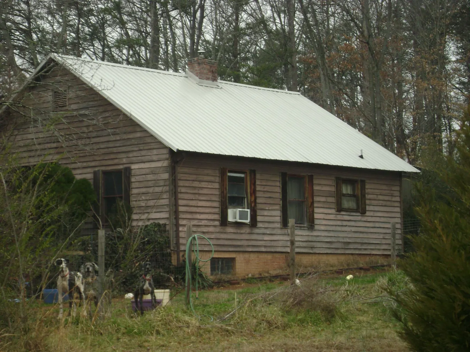 White metal roof on an old wood sided farmhouse, from a Metal Roof Installation job in Glyndon